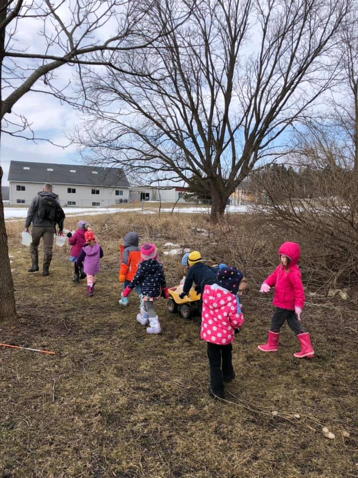 Adult and children walking outdoors on a path