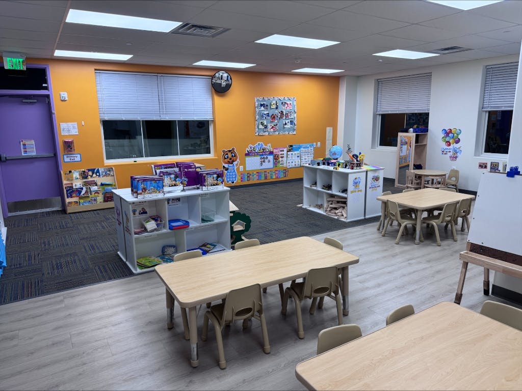 Empty classroom with small tables and chairs