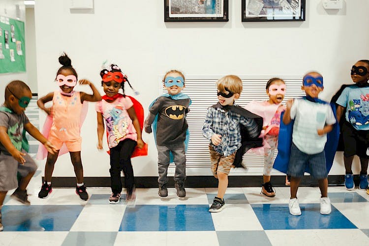 Group of children in superhero costumes and masks
