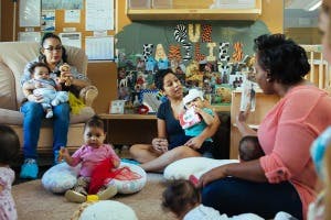 Adults and babies in a room