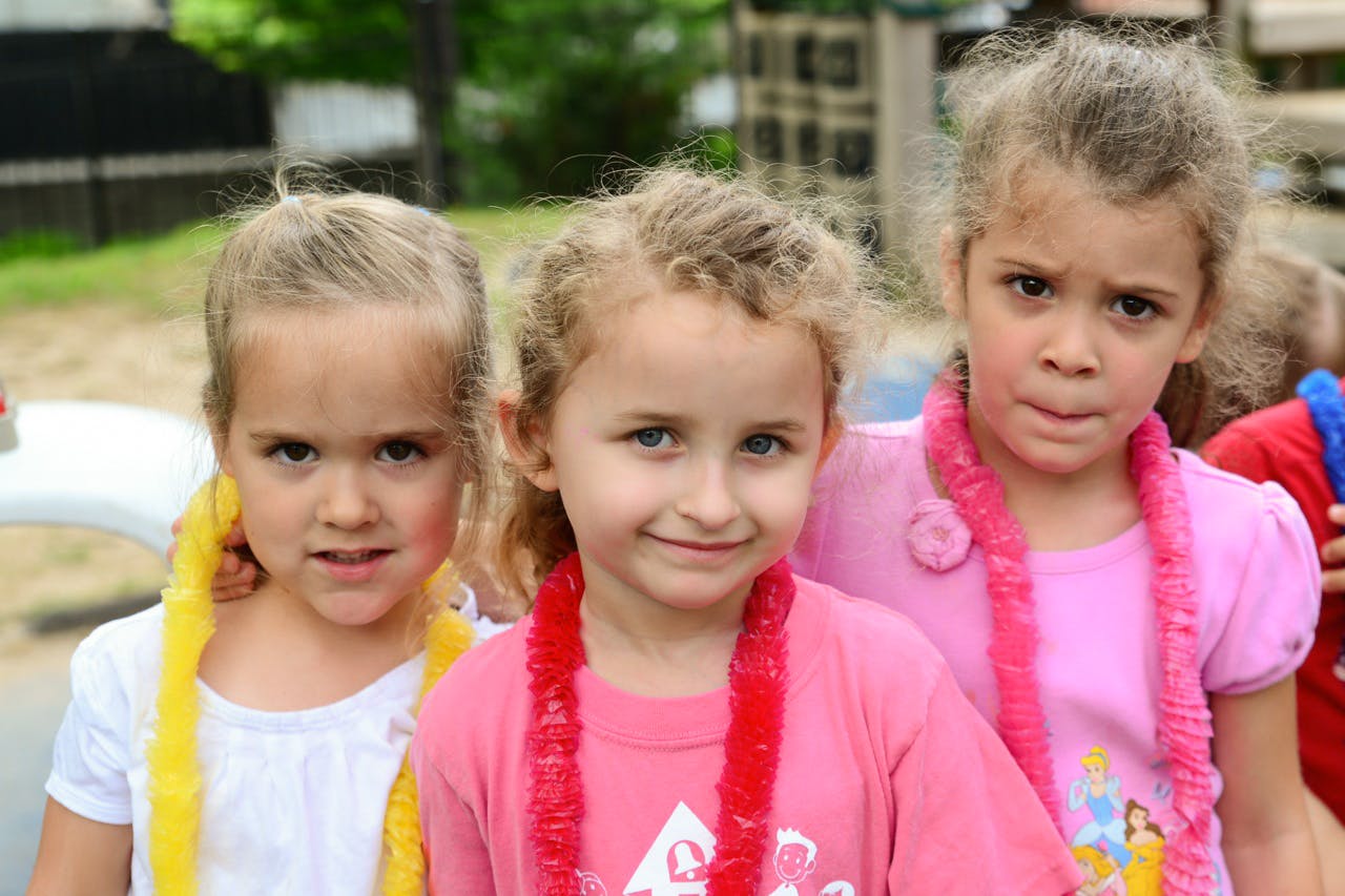 Three children wearing leis