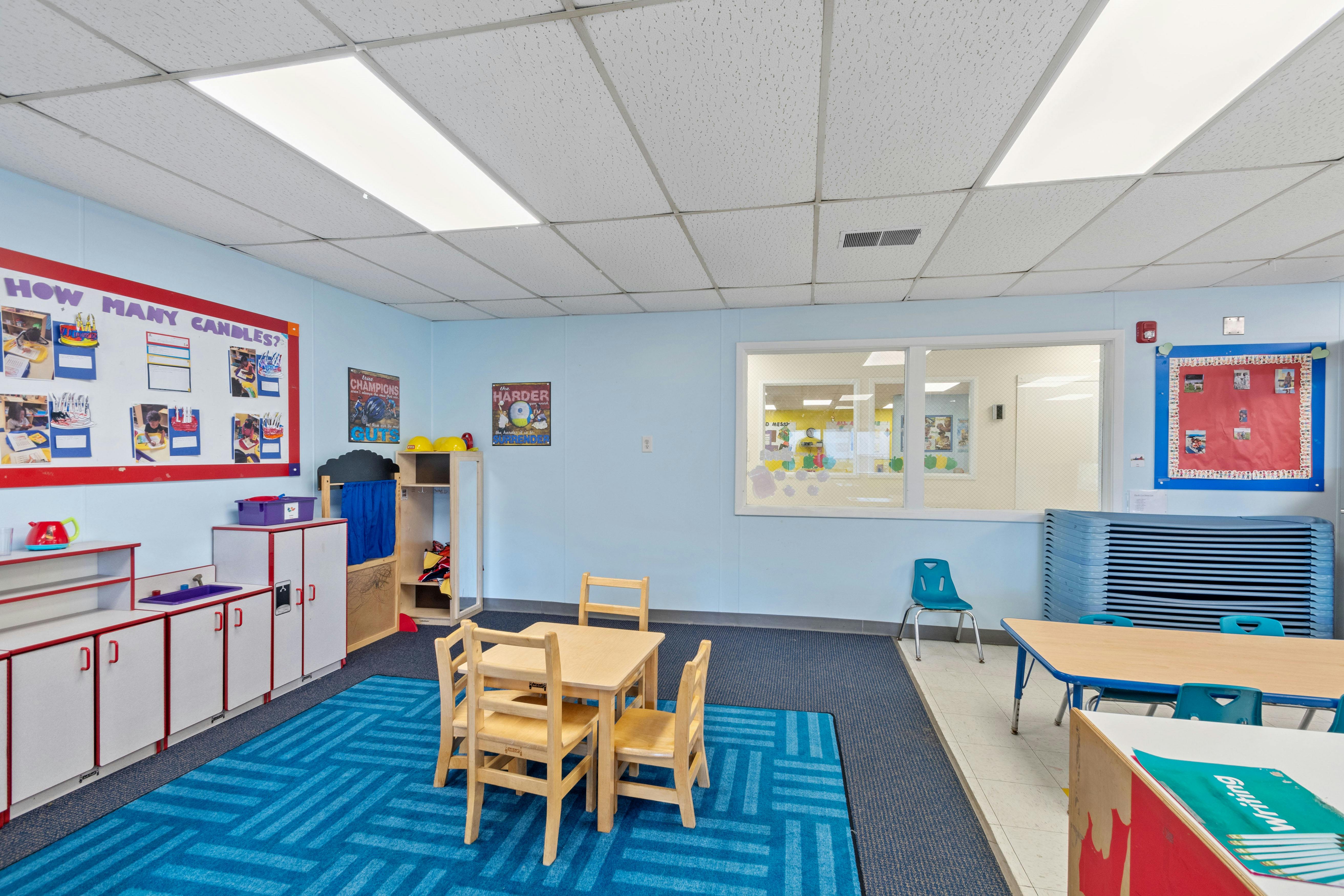 Empty colorful children's classroom with small tables and chairs