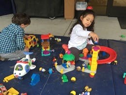 Two children playing with toys on the floor