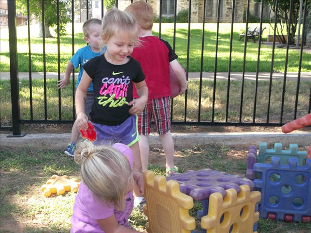 Children playing outdoors with plastic toys