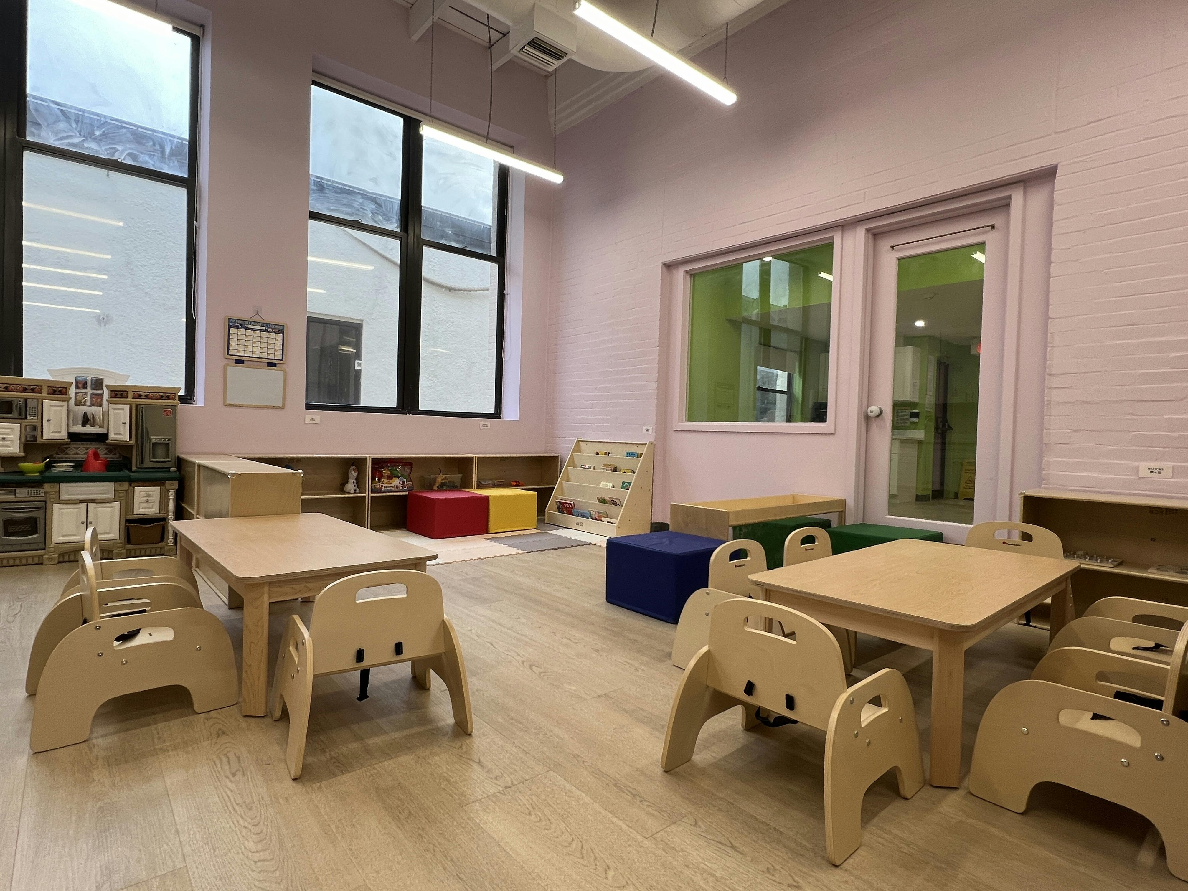 Empty classroom with small tables and chairs