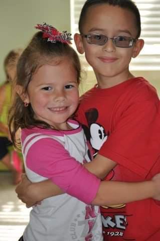 Two children hugging and smiling