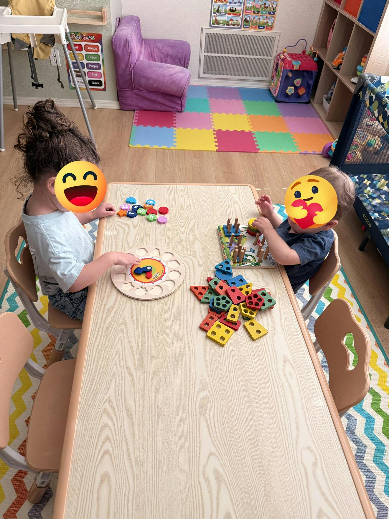 Two children playing with colorful wooden toys at a small table