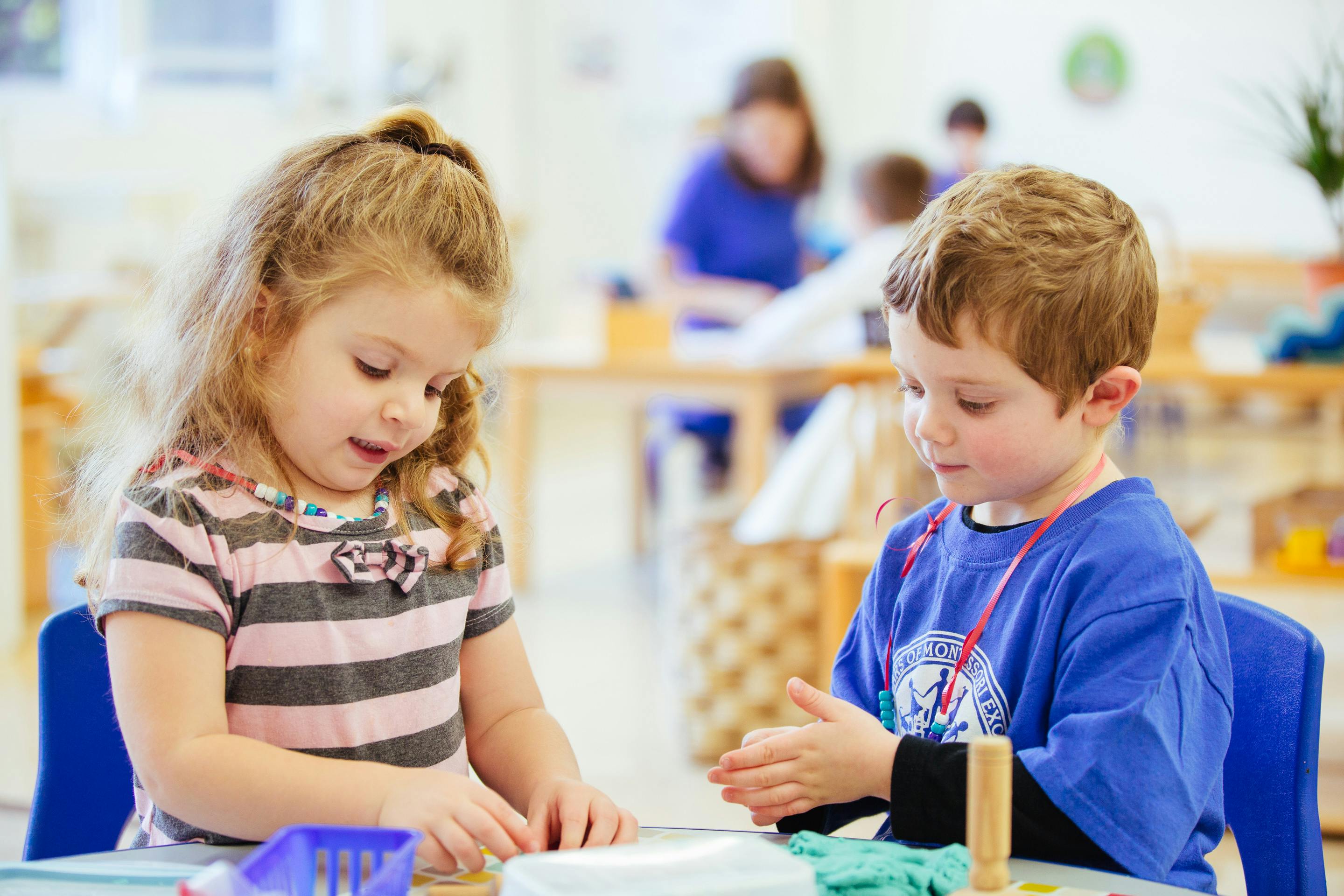 Two children at a table in a classroom