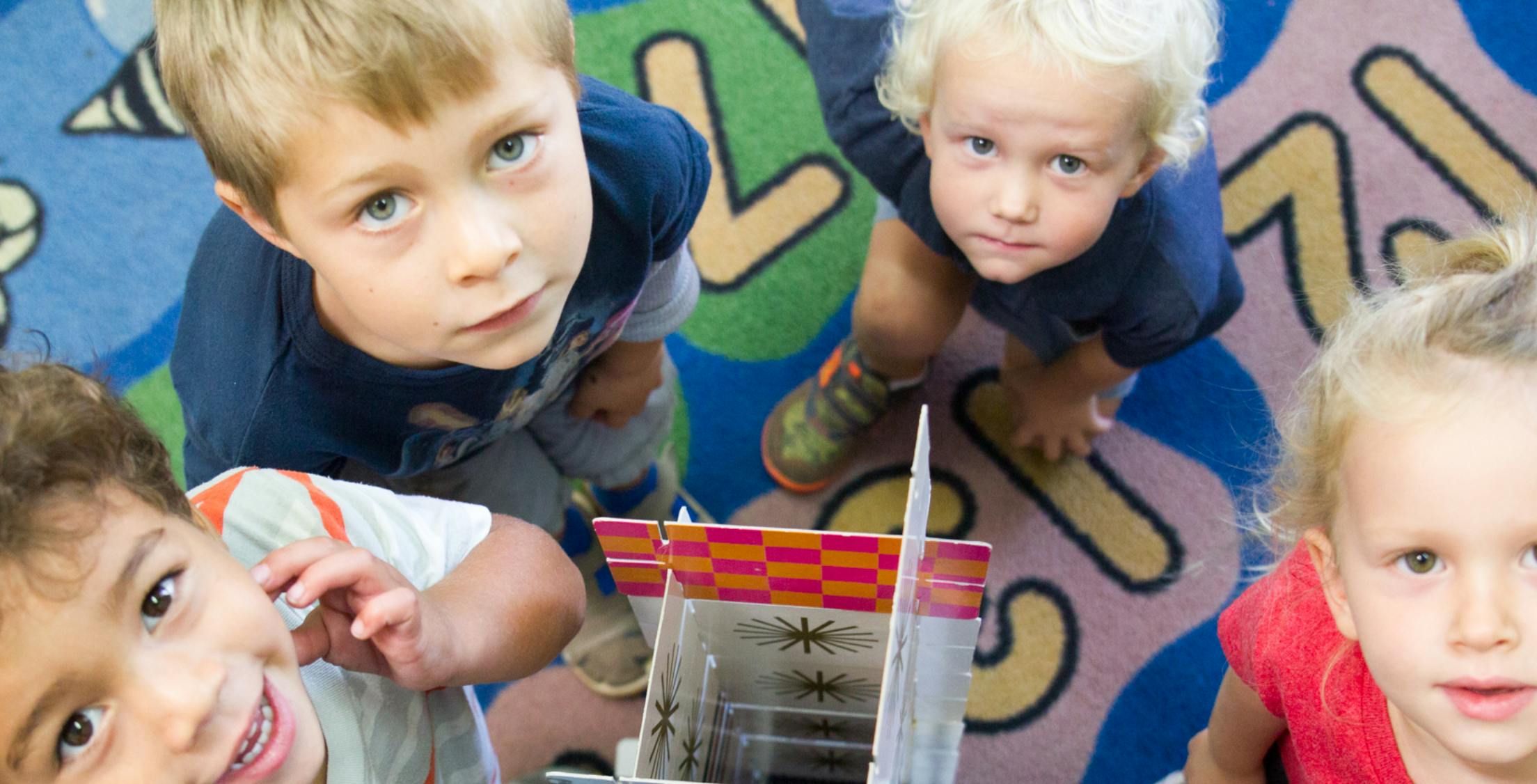 Three children looking up at the camera
