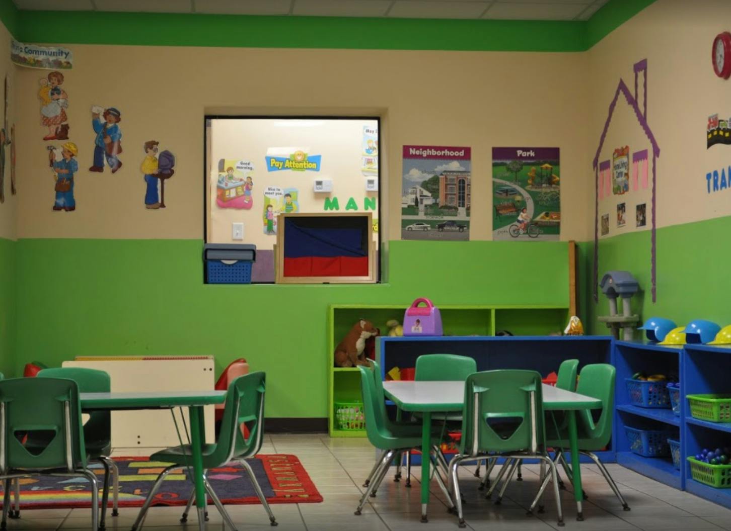 Classroom with small green tables and chairs
