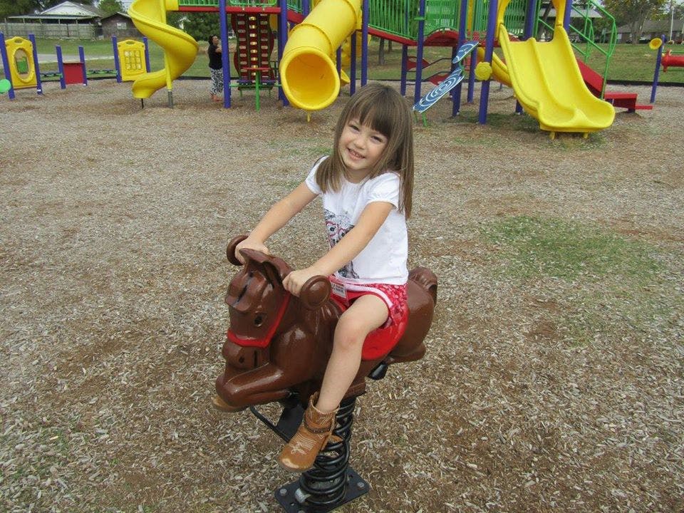 Child on a spring rider at a playground