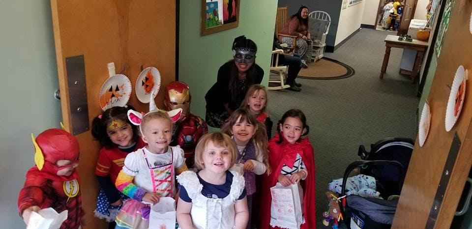 Children in costumes holding bags