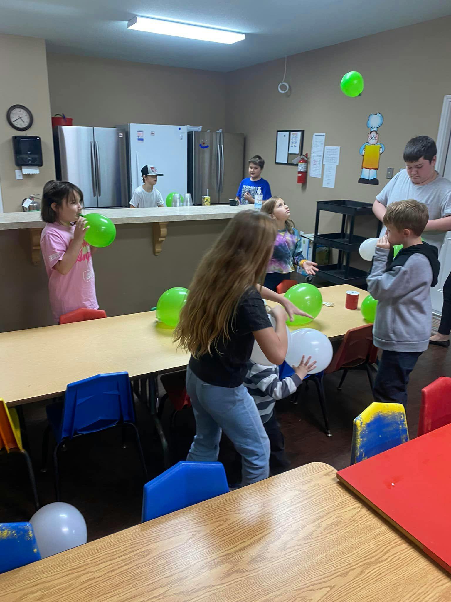 Children playing with balloons in a room