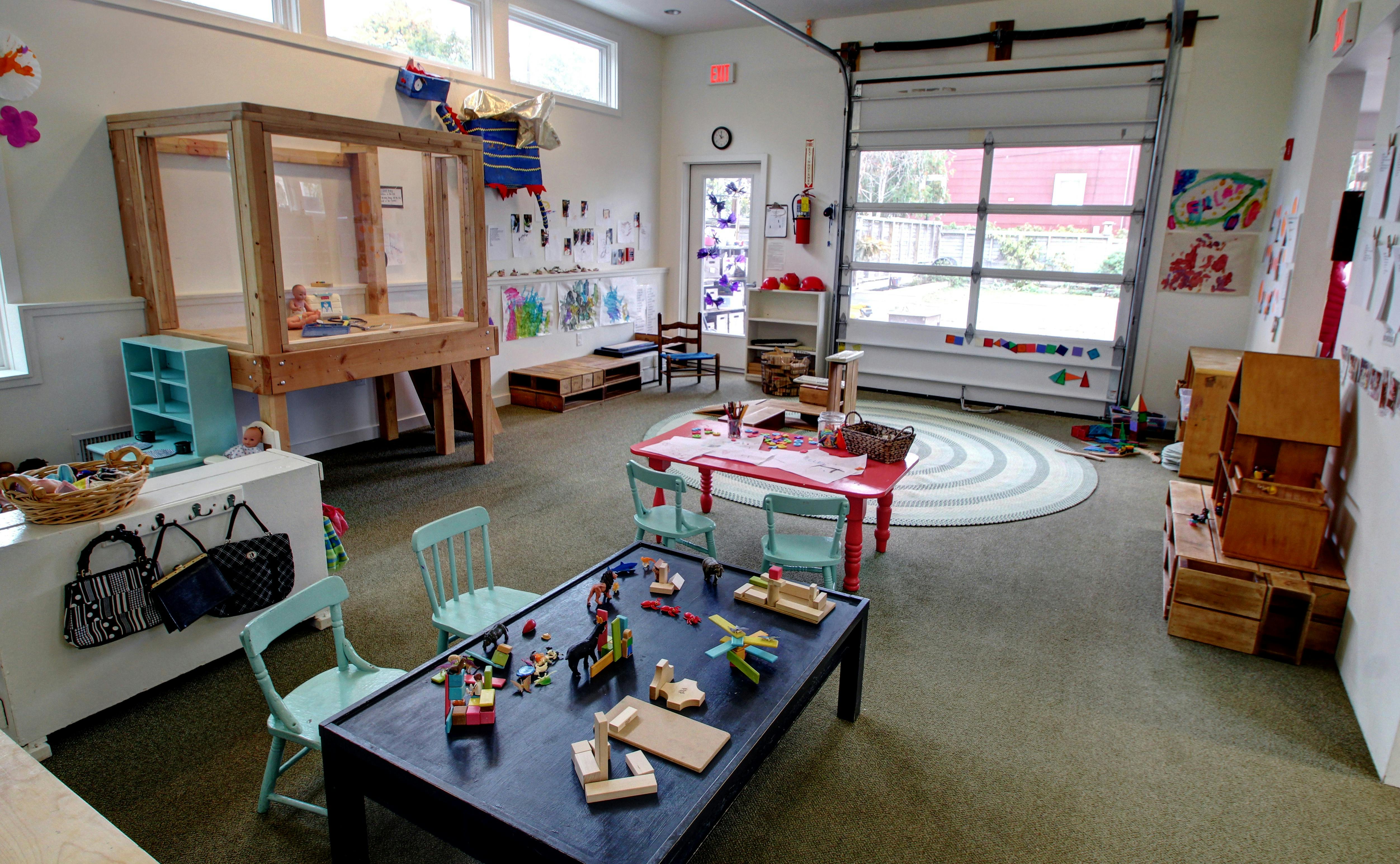 Playroom with tables, chairs, and toys