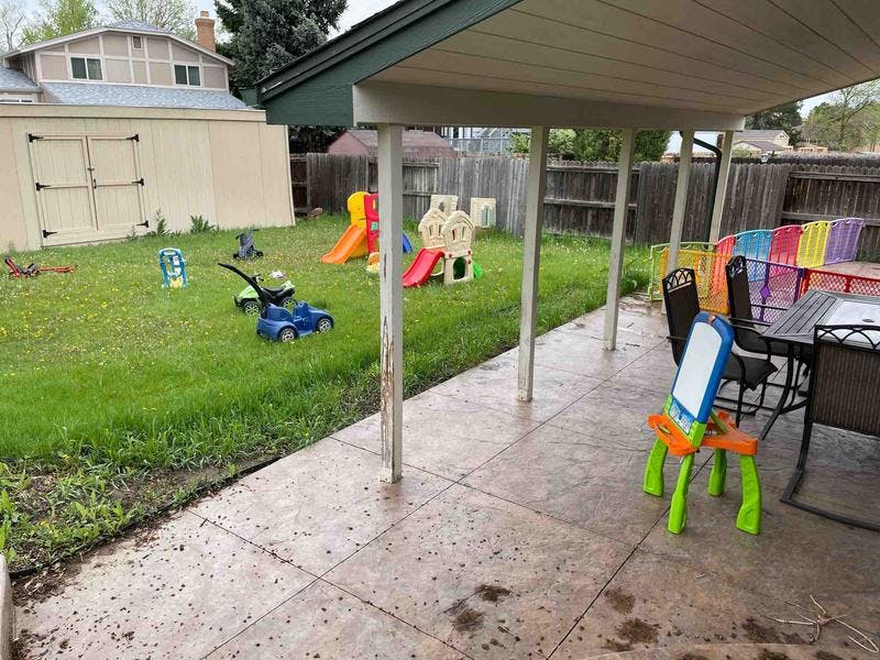 Backyard with a patio, play equipment, and a shed