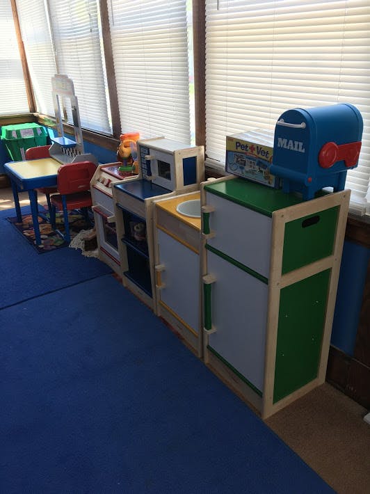 Children's play kitchen set with a table and chairs