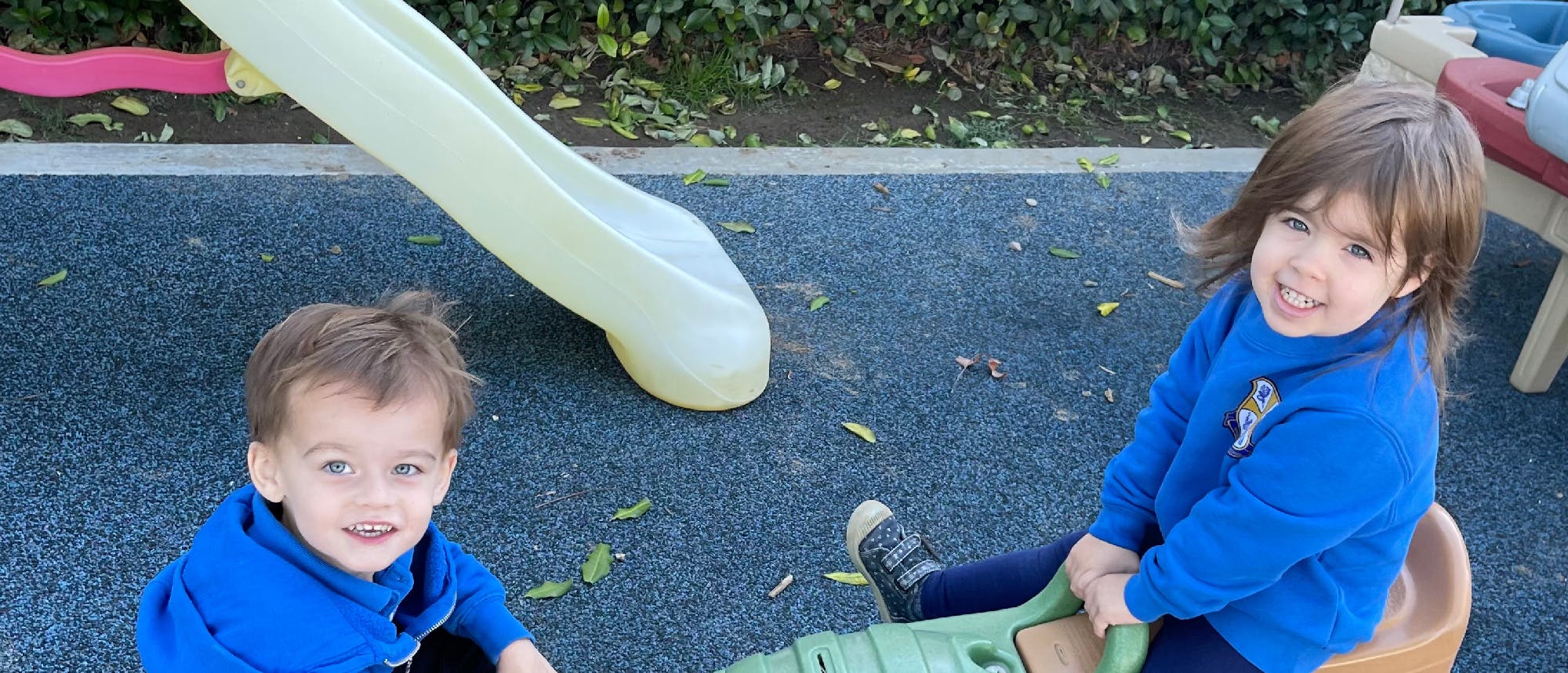 Two children playing on a playground