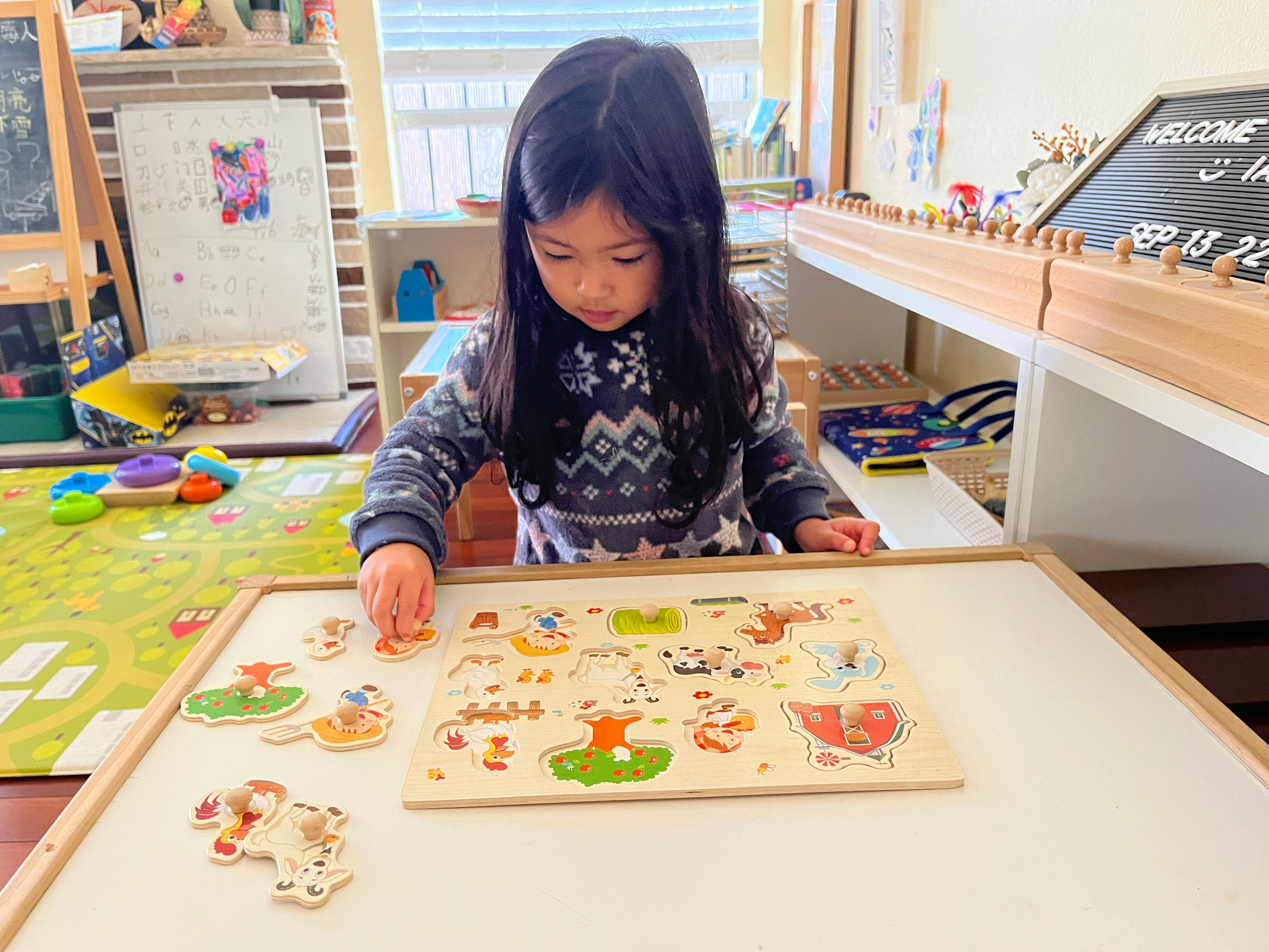 Child playing with a wooden puzzle on a table