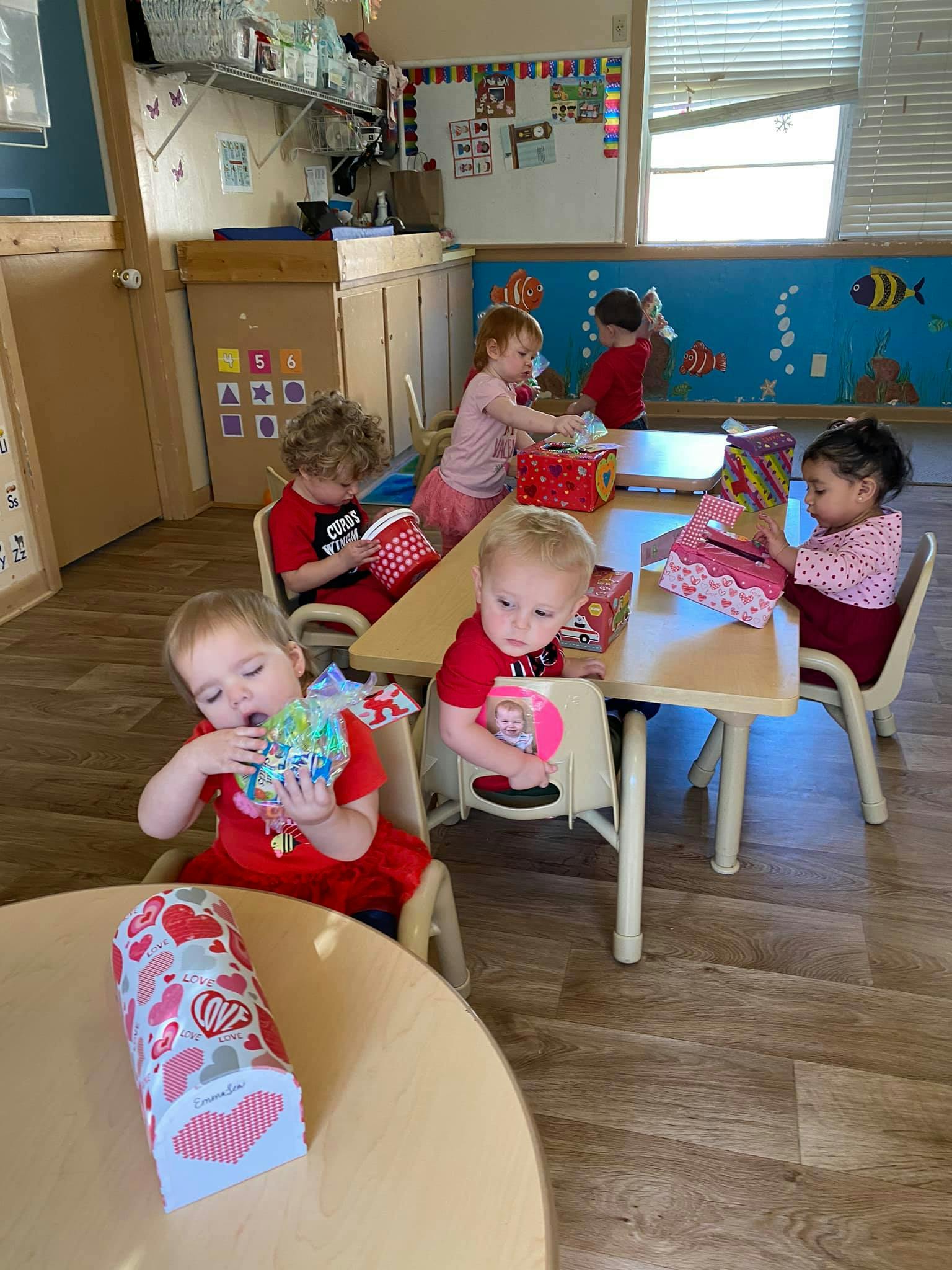 Children sitting at tables in a classroom