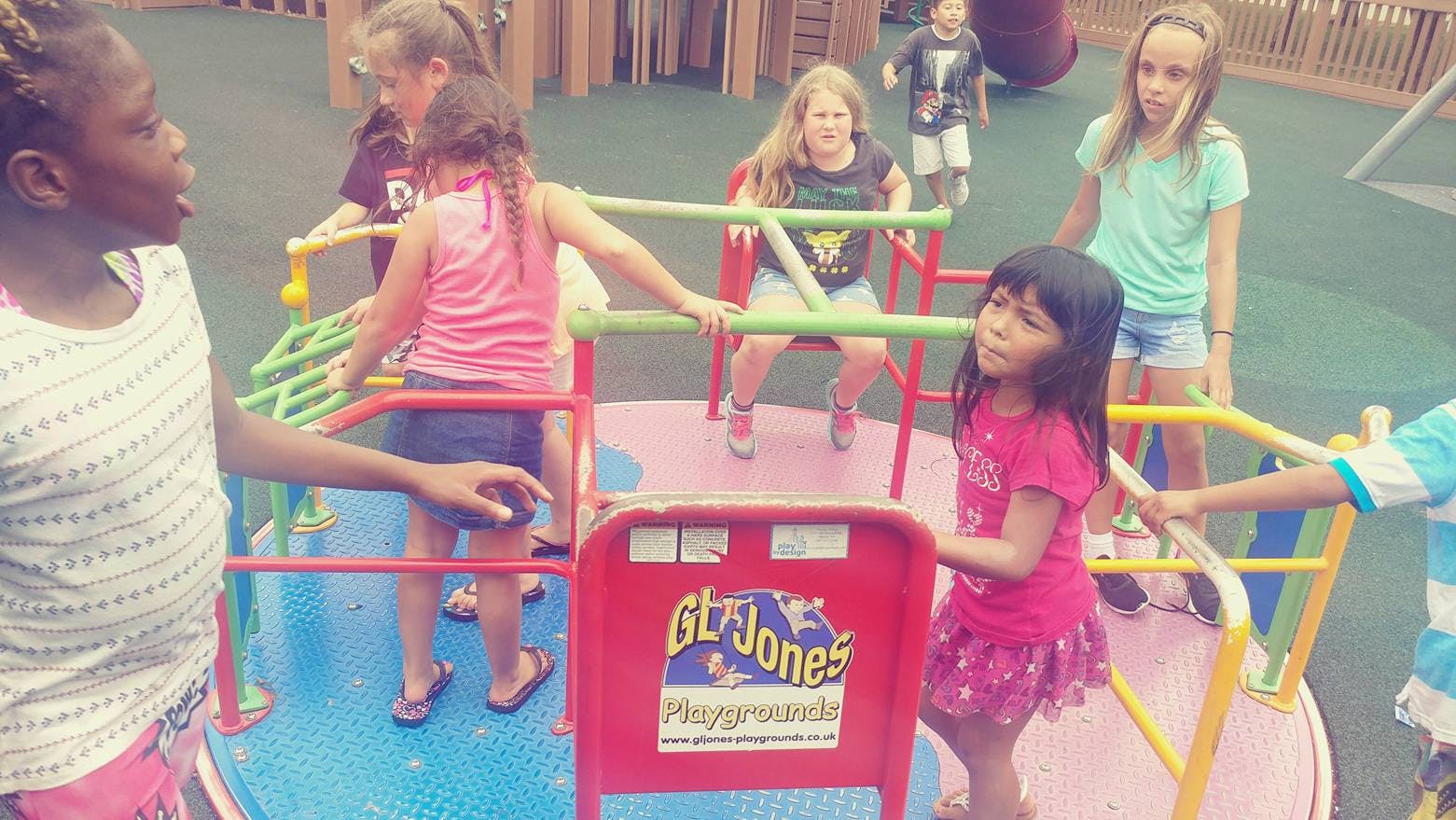 Children playing on a merry-go-round