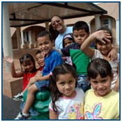 Adult and multiple children posing for a photo