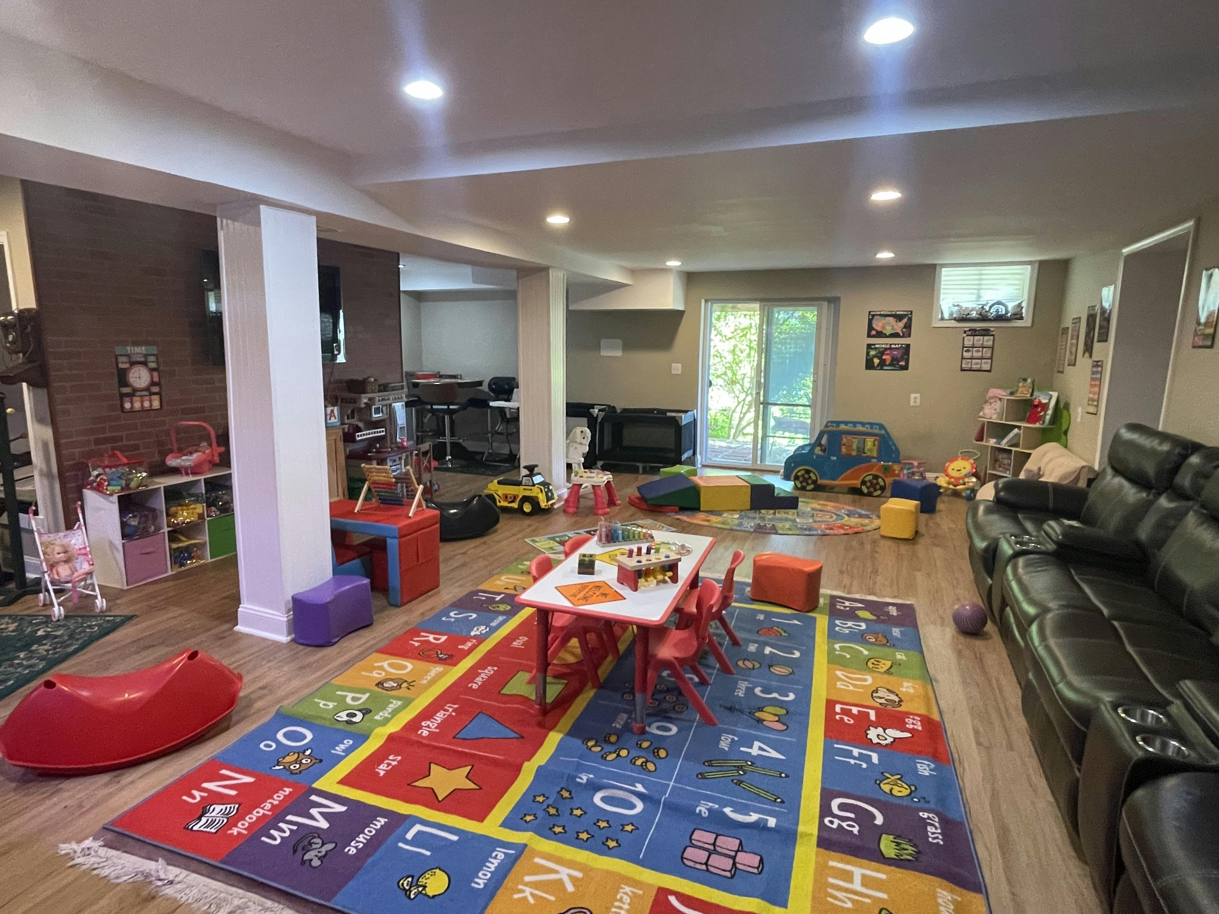 Playroom with a children's activity table and alphabet area rug
