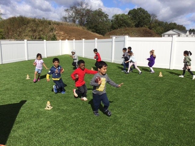 Children playing on a grassy field
