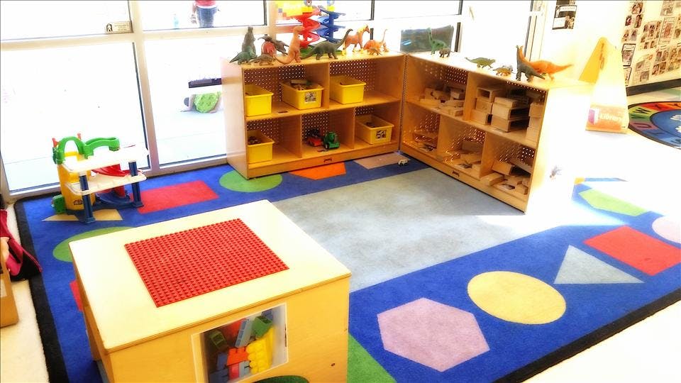 Classroom or play area with educational toys and shelves