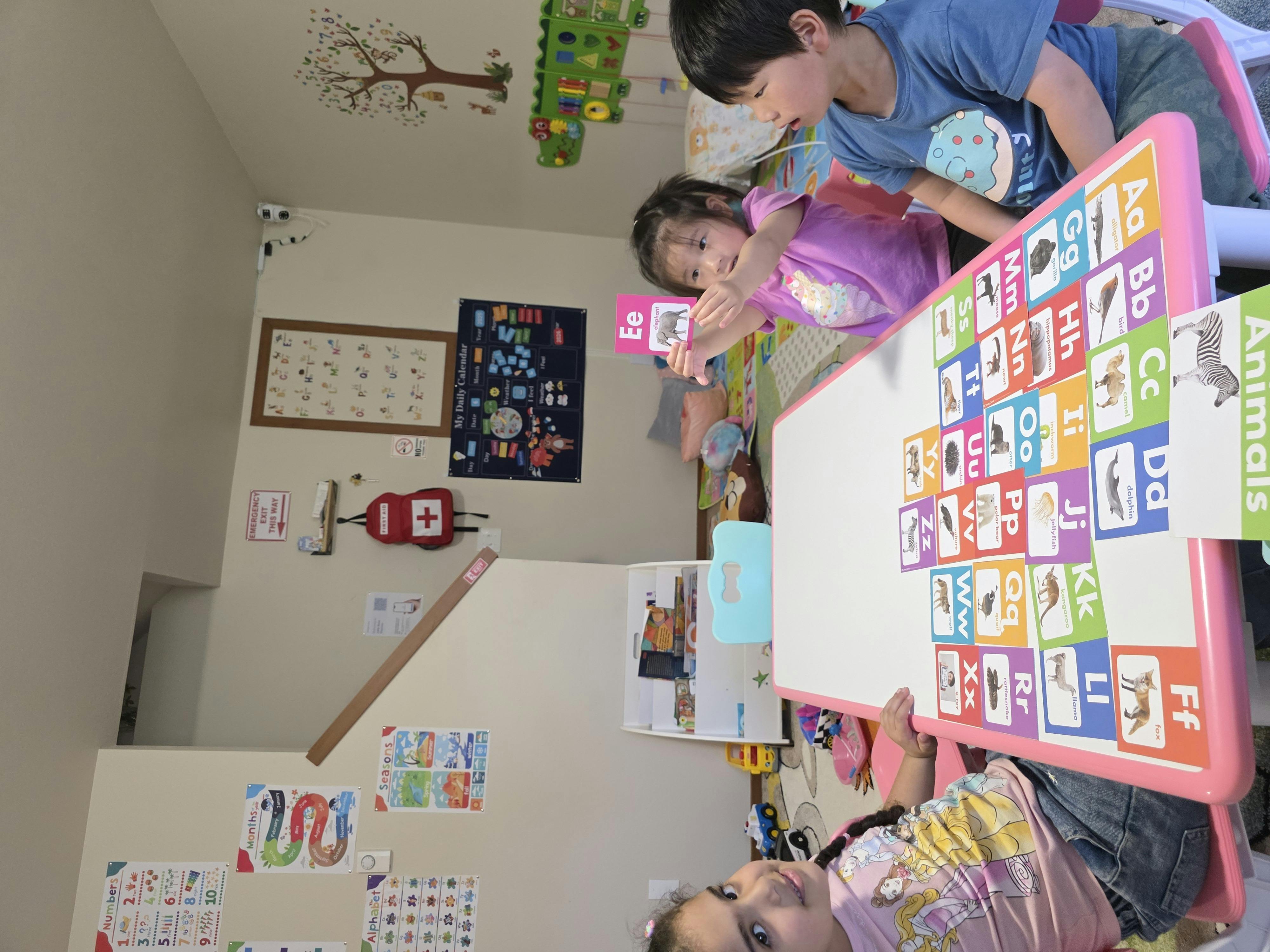 Children playing with alphabet cards at a table