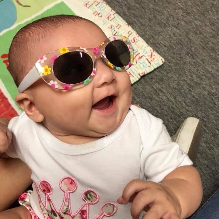 Child wearing floral sunglasses