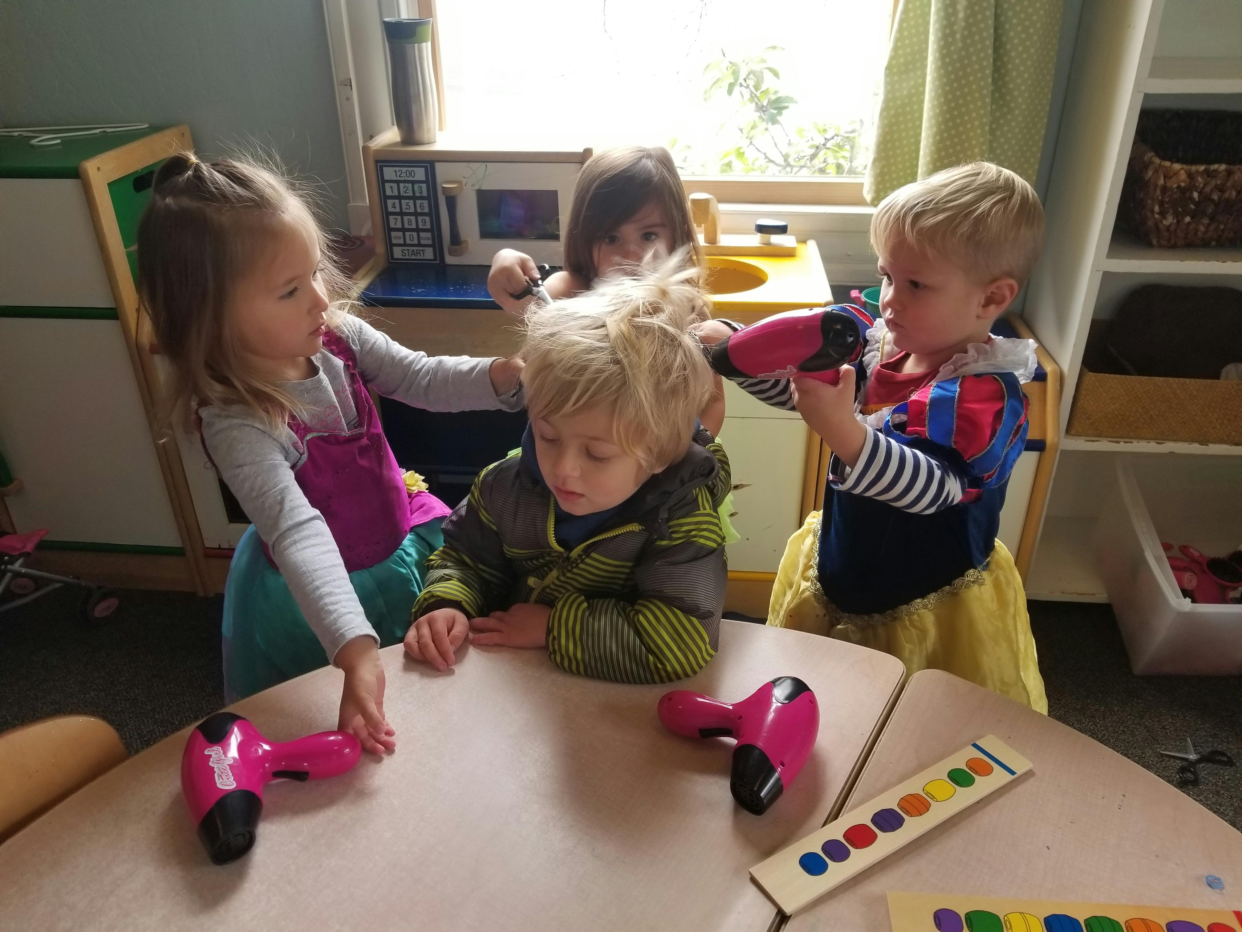 Children playing with toy hair dryers