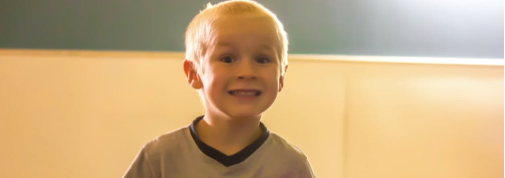 Child with light hair looking forward