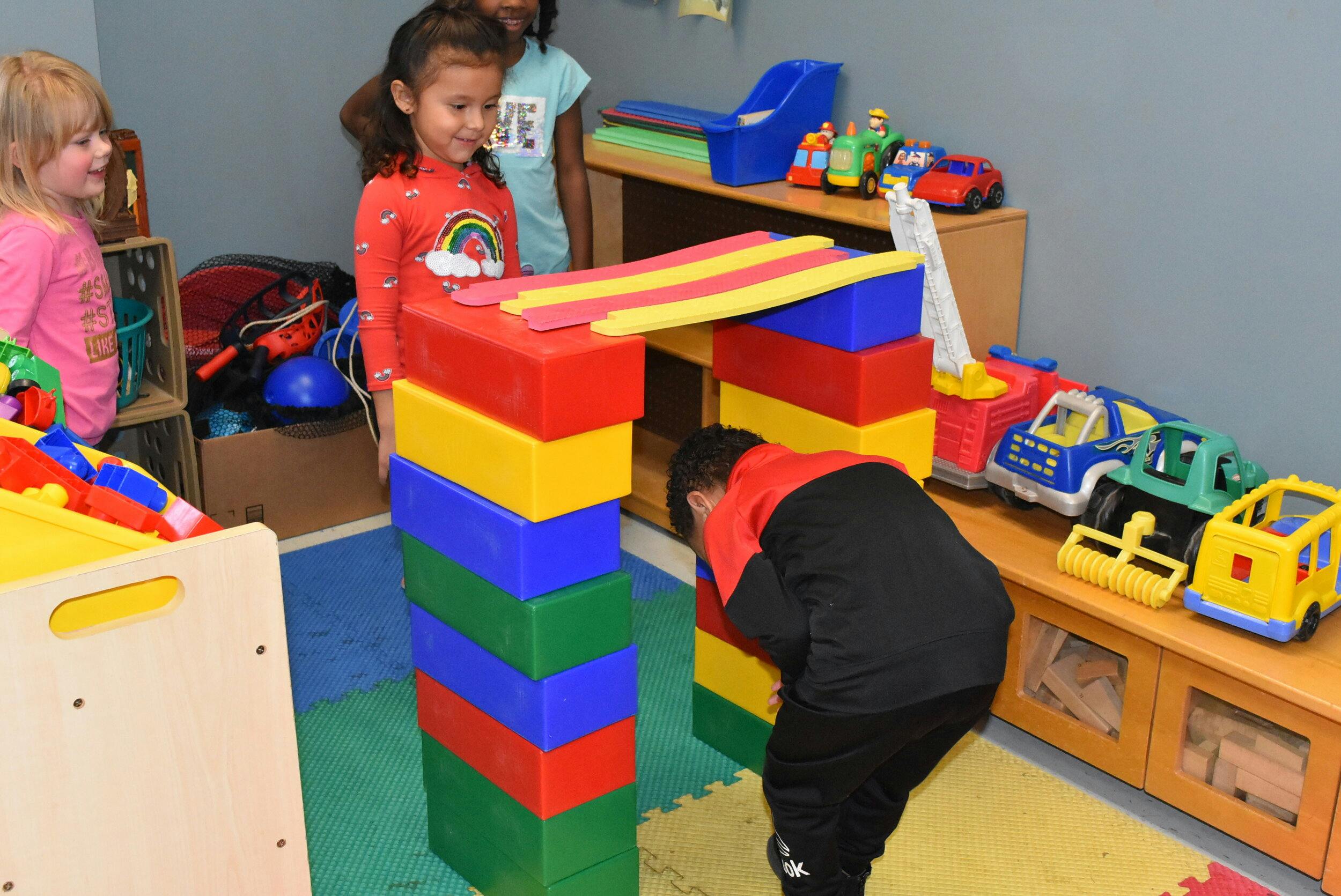 Children playing with large colorful building blocks