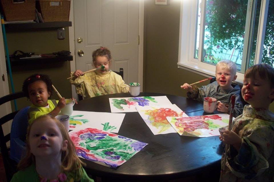 Children painting at a table