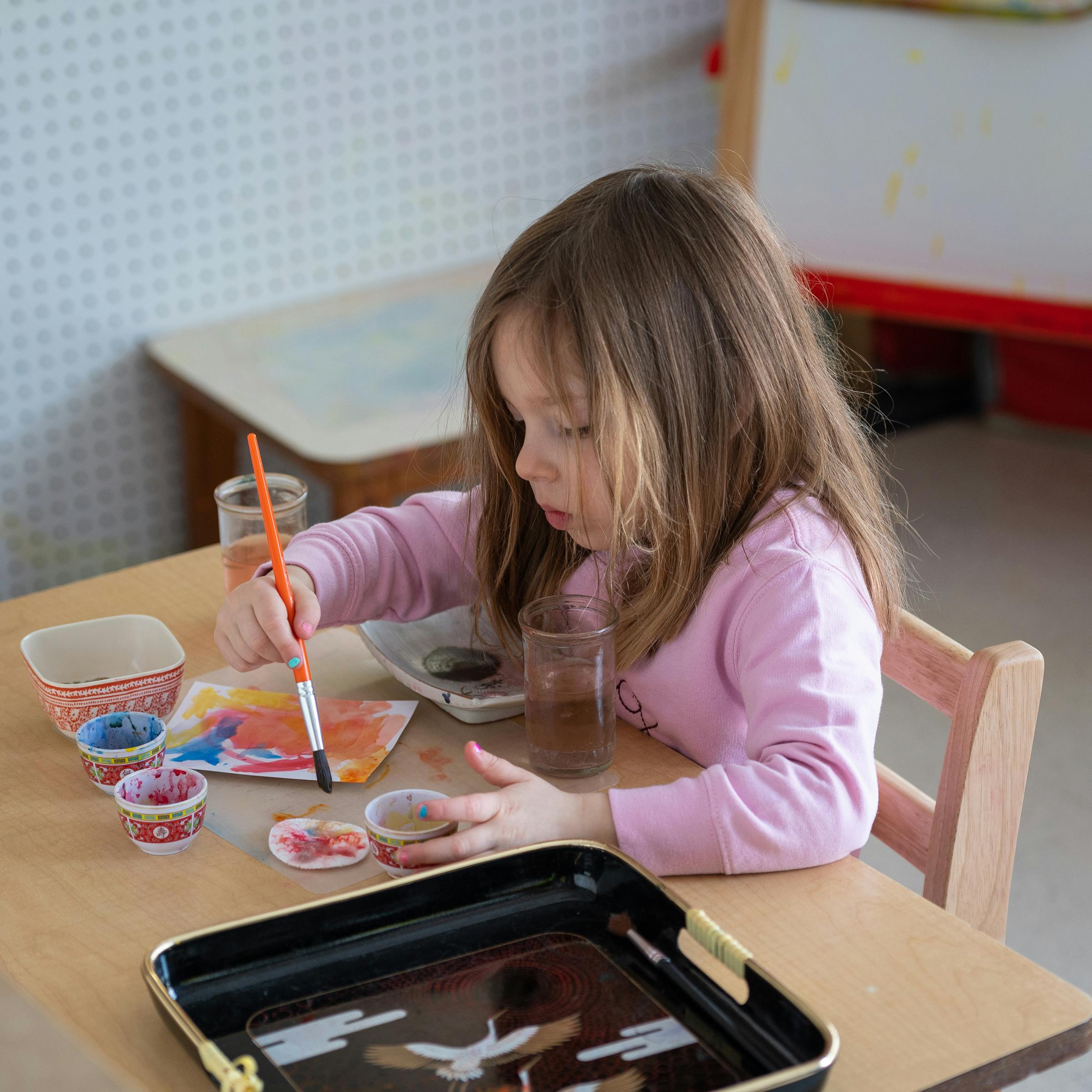 Child painting at a table
