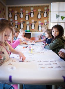 Children sitting at a table doing an activity