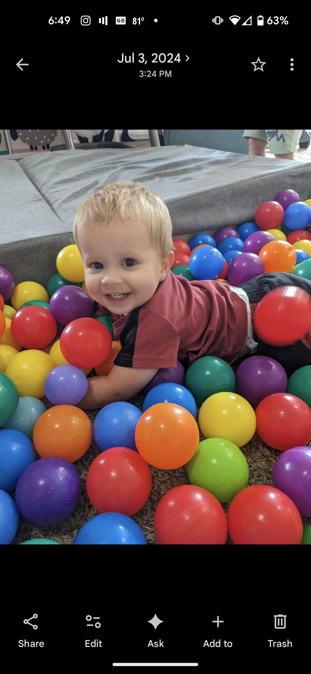 Child smiling in a ball pit