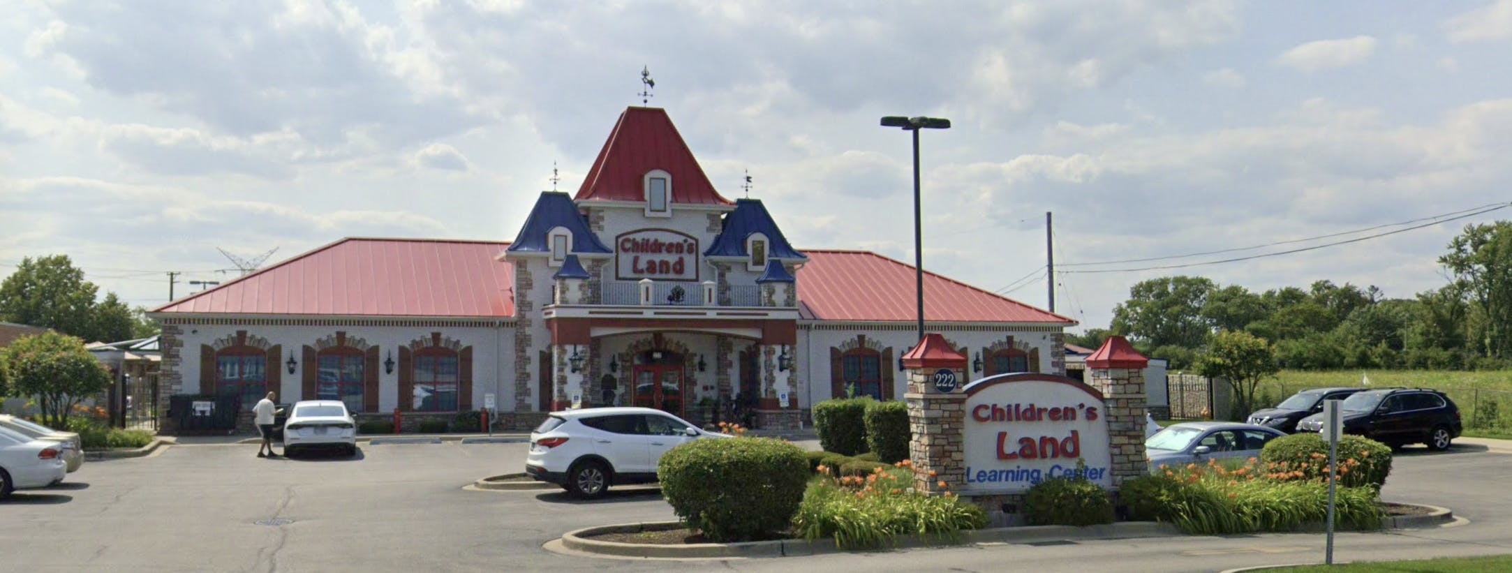 Building with red roof and castle-like facade, sign reads Children's Land