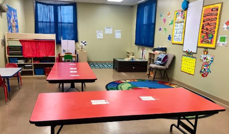 Classroom with red tables and colorful decorations