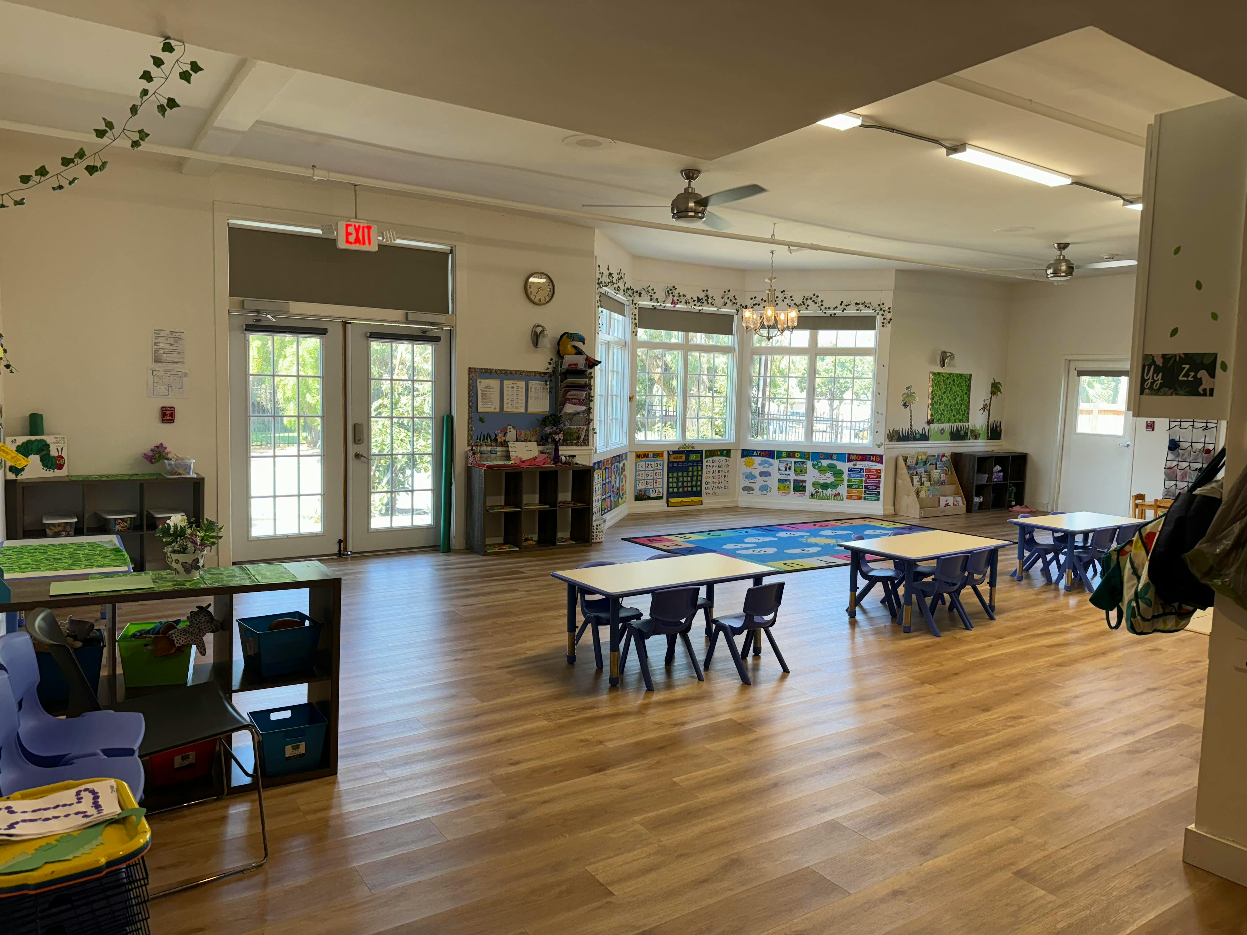 Empty classroom with small tables and chairs