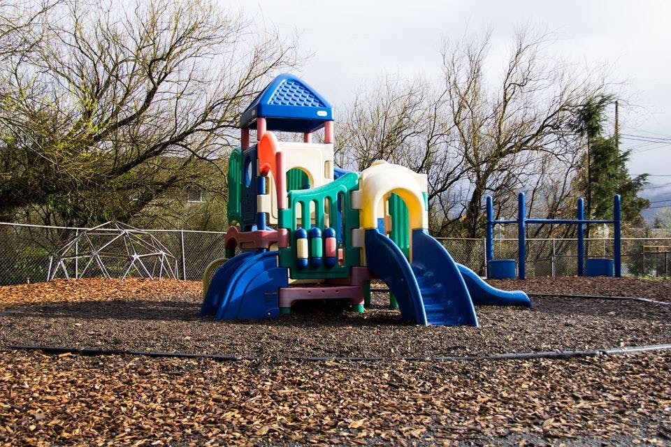 Colorful playground structure with slides and climbing areas