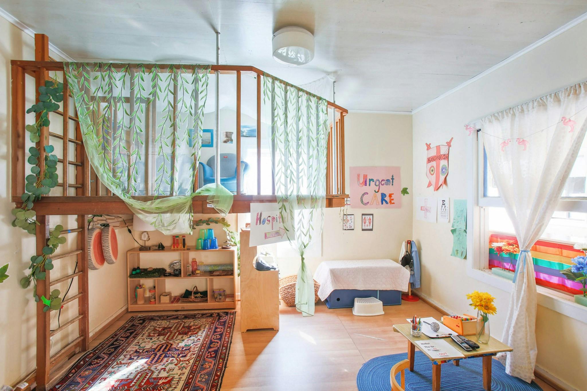 Children's play area with a wooden loft and a small table with chairs