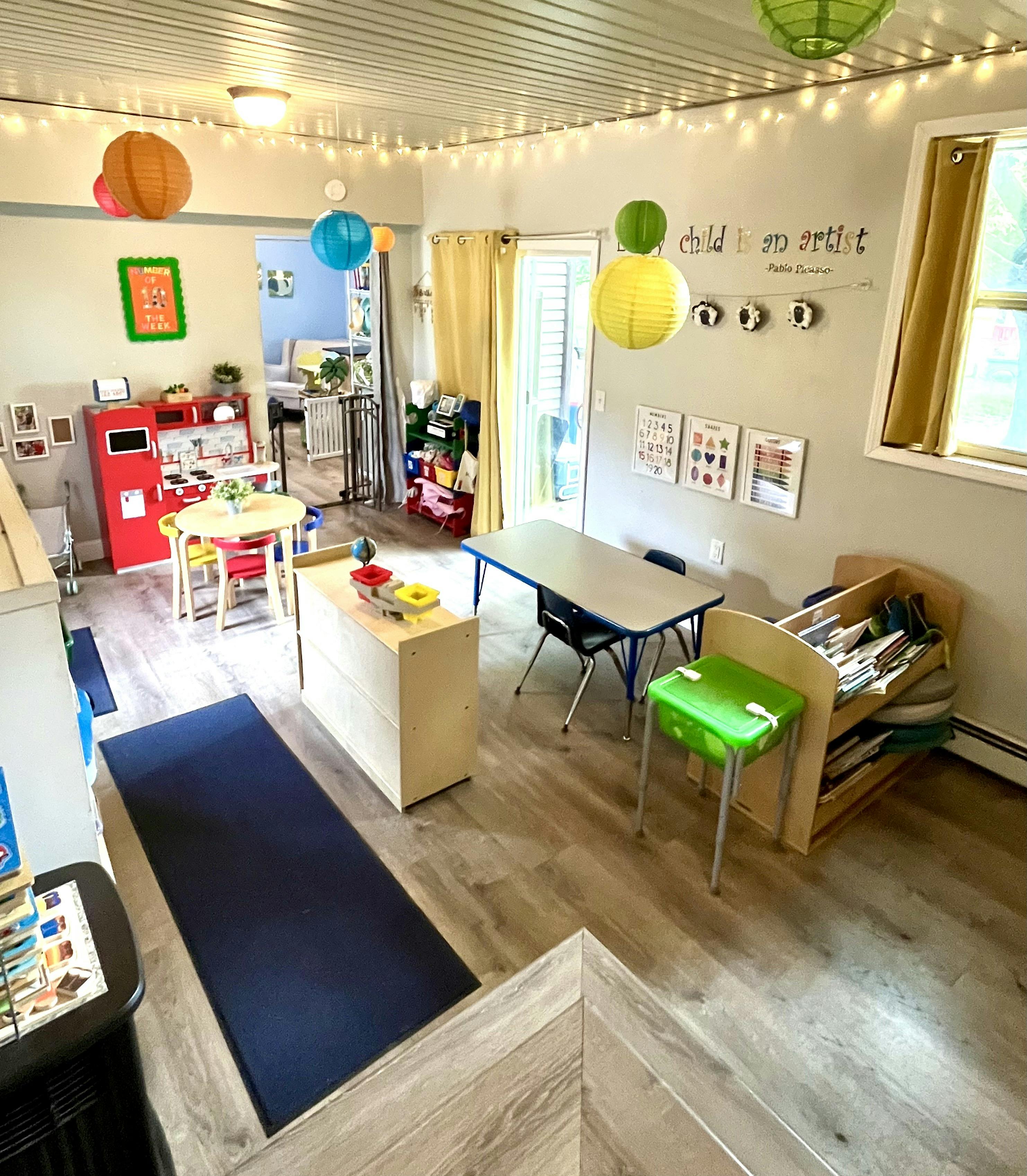 Playroom with small tables, chairs, and toys