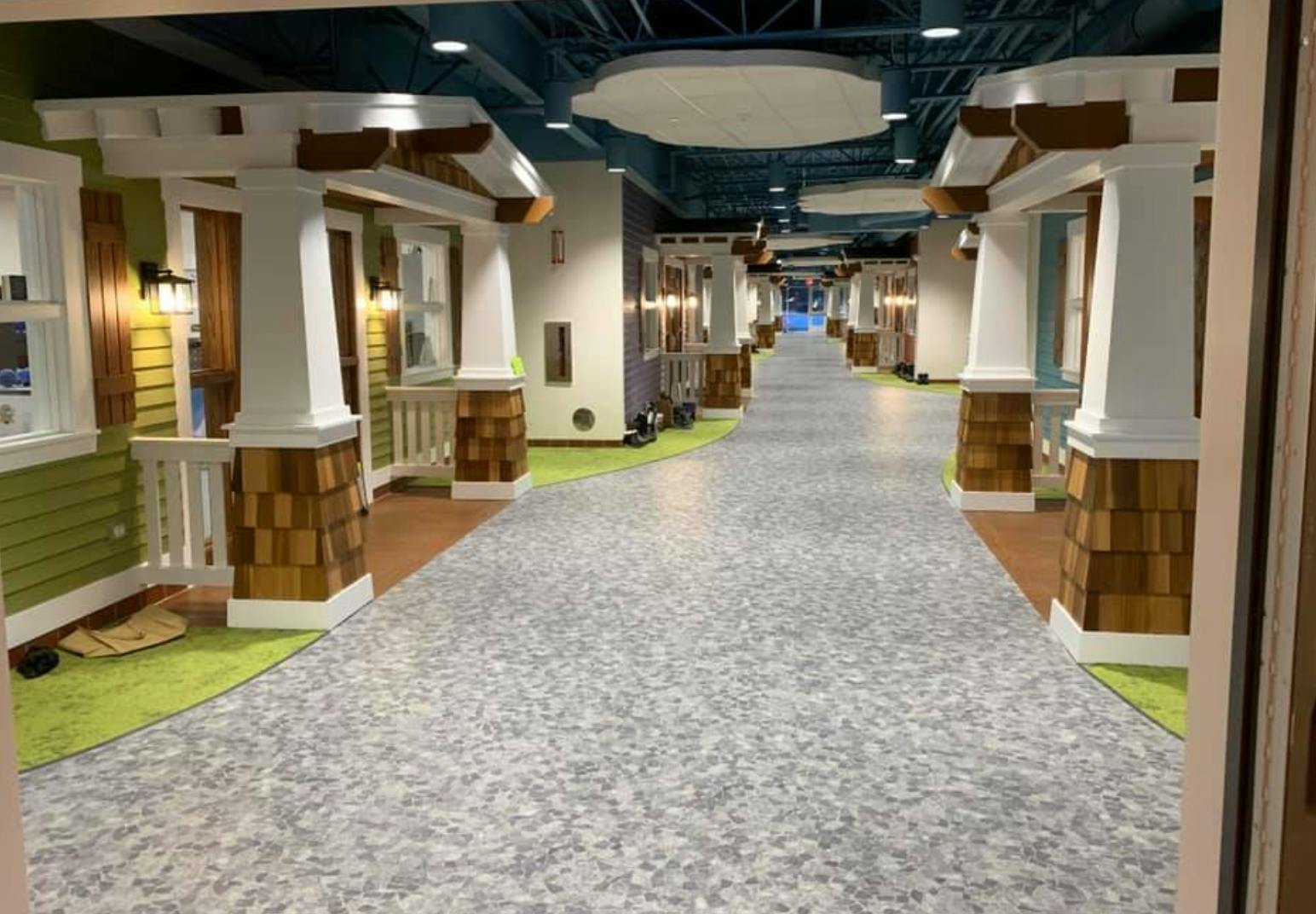 Hallway with miniature house facades lining both sides