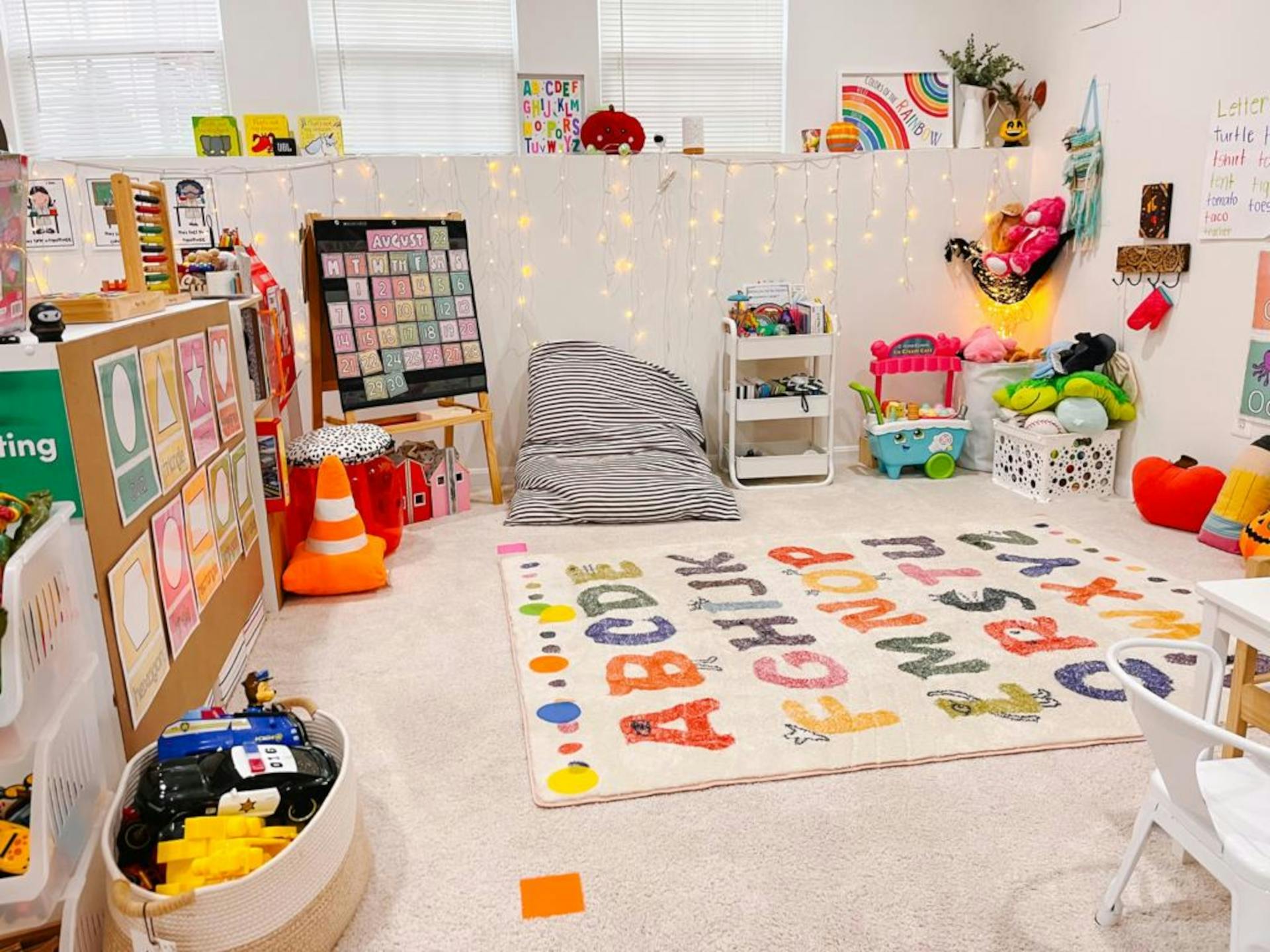 Playroom with an alphabet rug, beanbag chair, and various toys