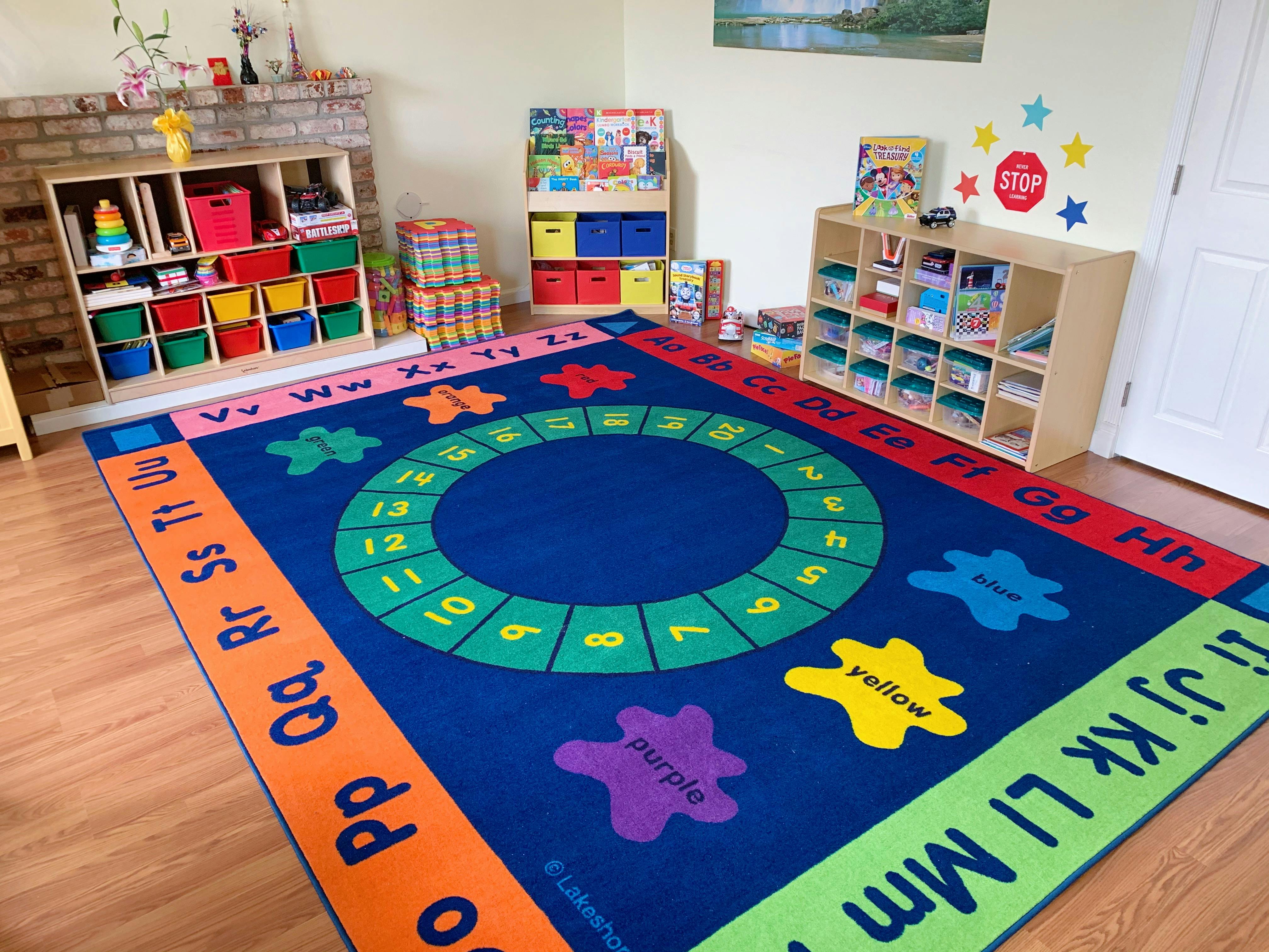 Classroom with a colorful alphabet and number rug