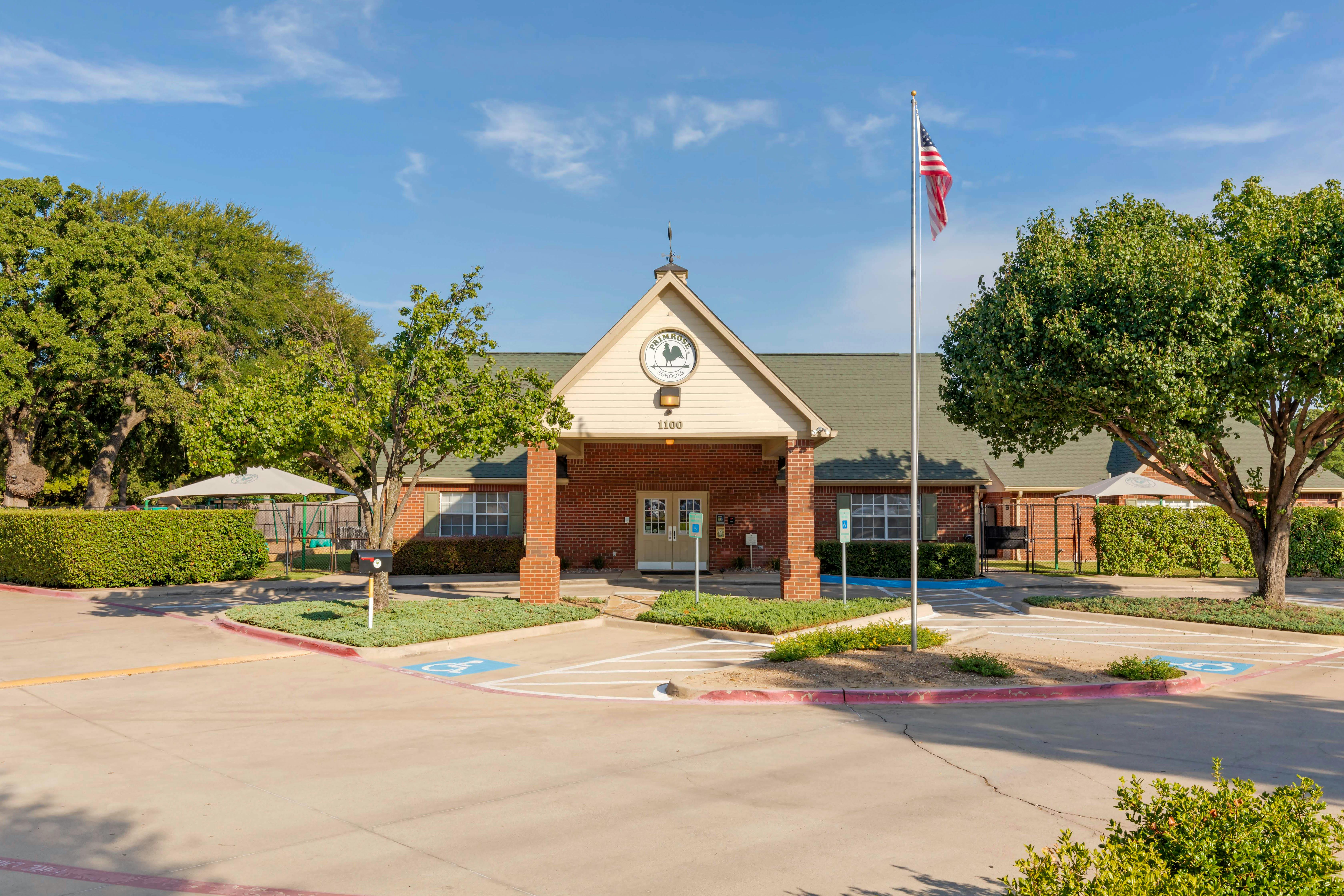 Primrose Schools building with an American flag and accessibility parking spots