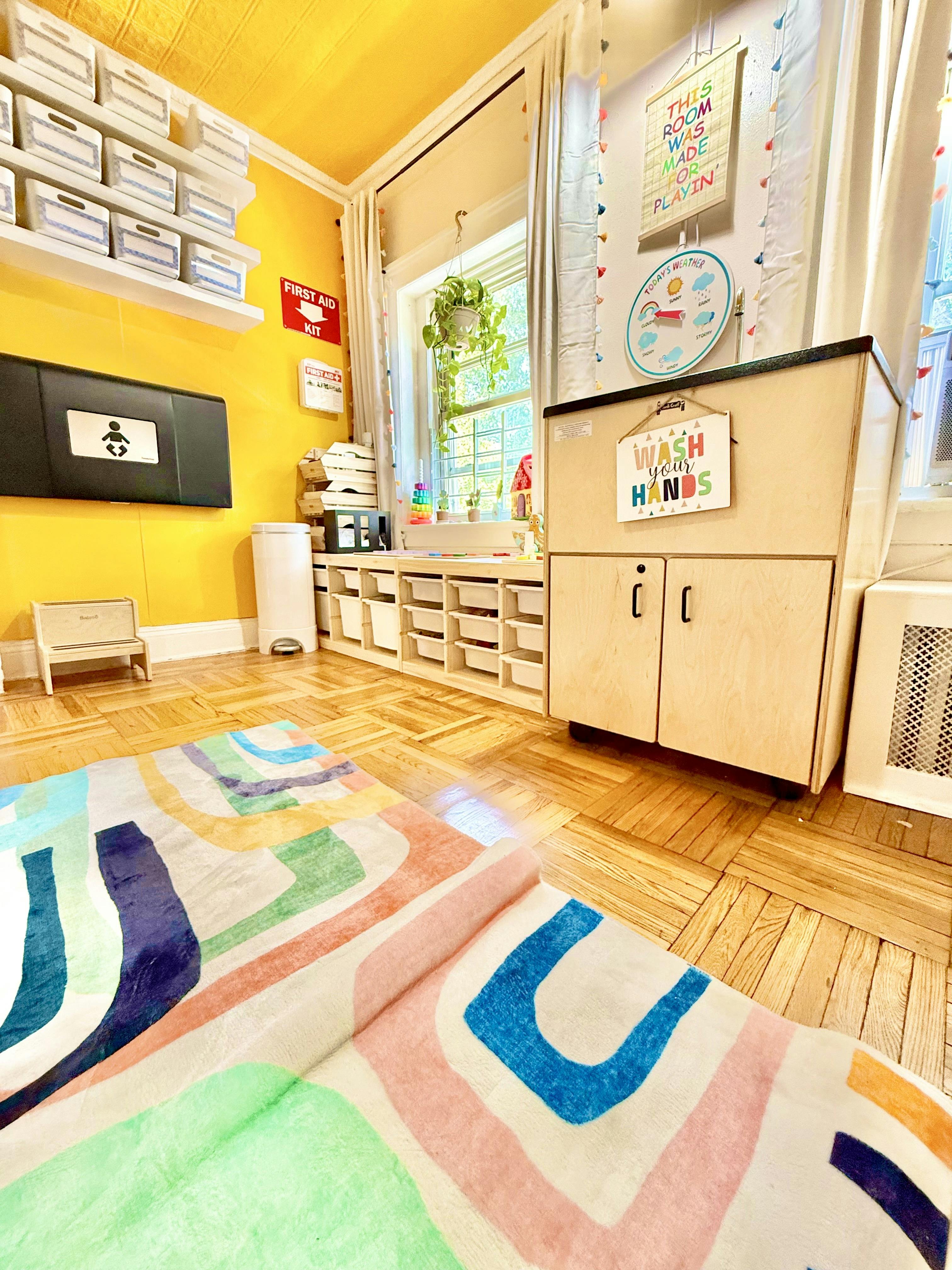 Classroom with a changing station, storage, and colorful rug