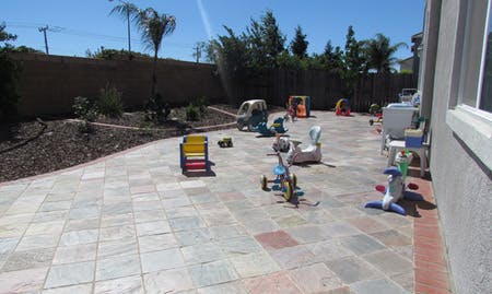 Paved patio with various children's toys