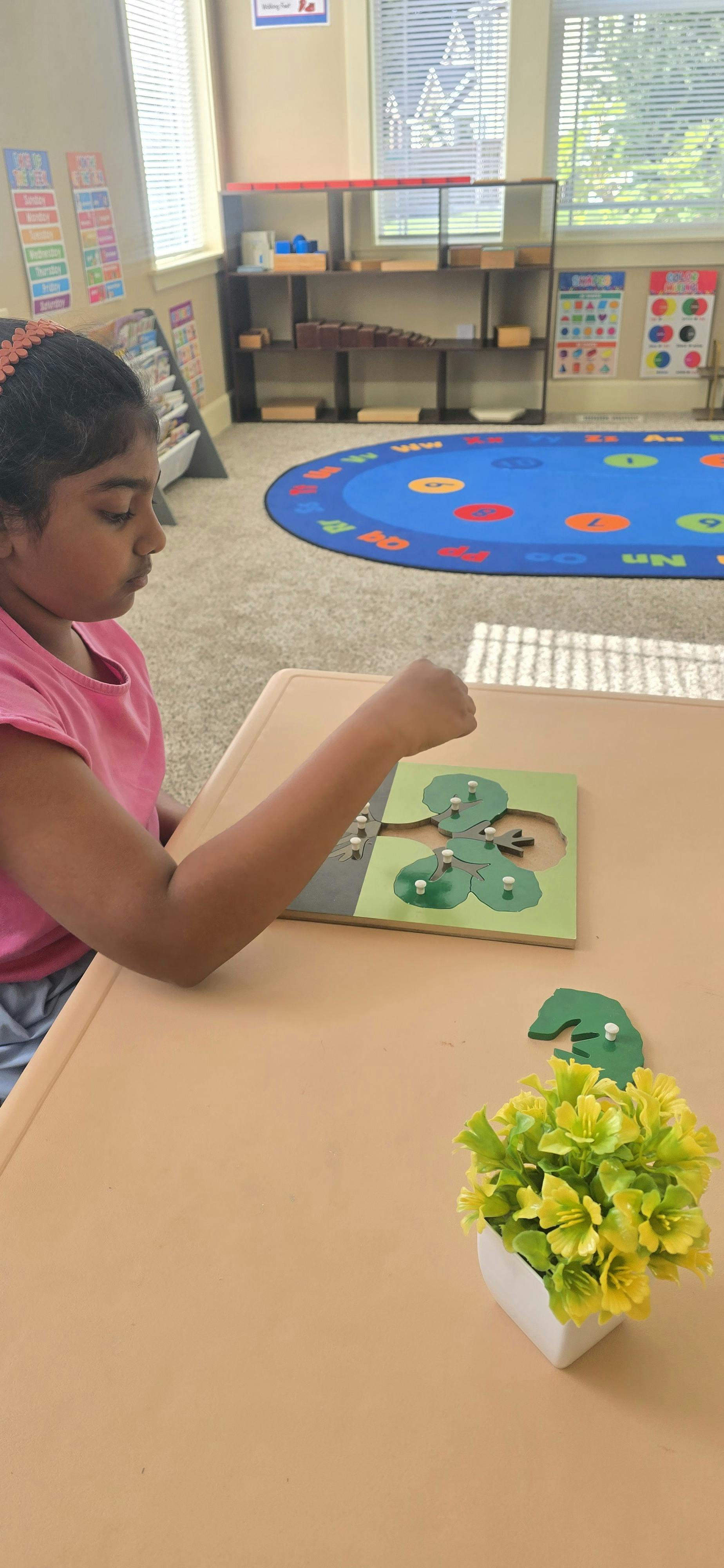 Child manipulating a tree-shaped puzzle with small pegs